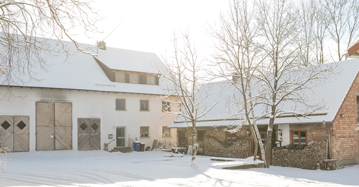 Blick auf den Bauernhof mit Schlemmerstall im Winter